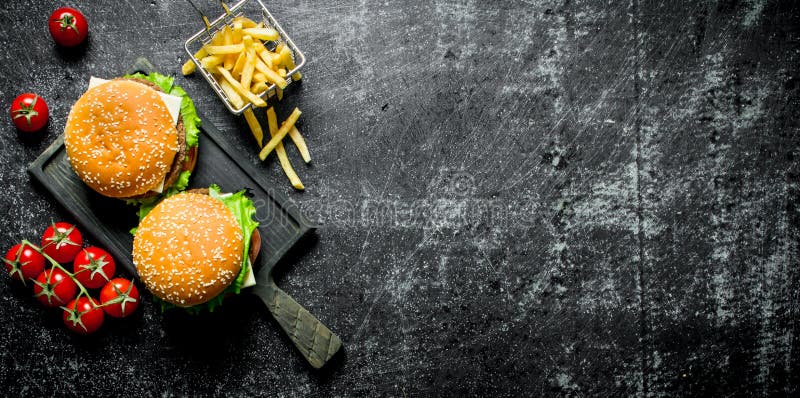 Burgers with fries and tomatoes