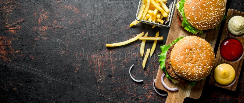 Burgers with fries and various sauces