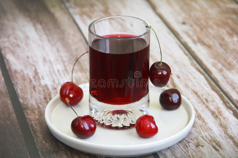Burgundy Cherry Drink in a Glass and Natural Cherry a Fruit Stock Image
