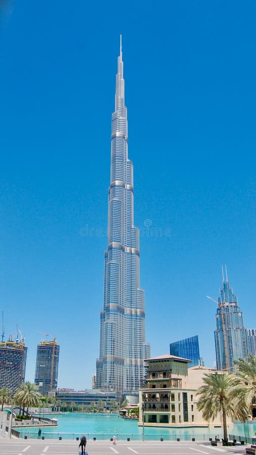 Burj Khalifa world`s tallest tower against a deep blue sky background in Dubai, United Arab Emirates with reflective pond in front royalty free stock photography Burj Khalifa world`s tallest tower against a deep blue sky background in Dubai, United Arab Emirates with reflective pond in front royalty free stock photography