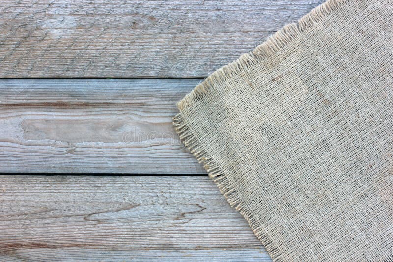 Burlap on the wooden background, top view. empty space stock photo Burlap on the wooden background, top view. empty space stock photo