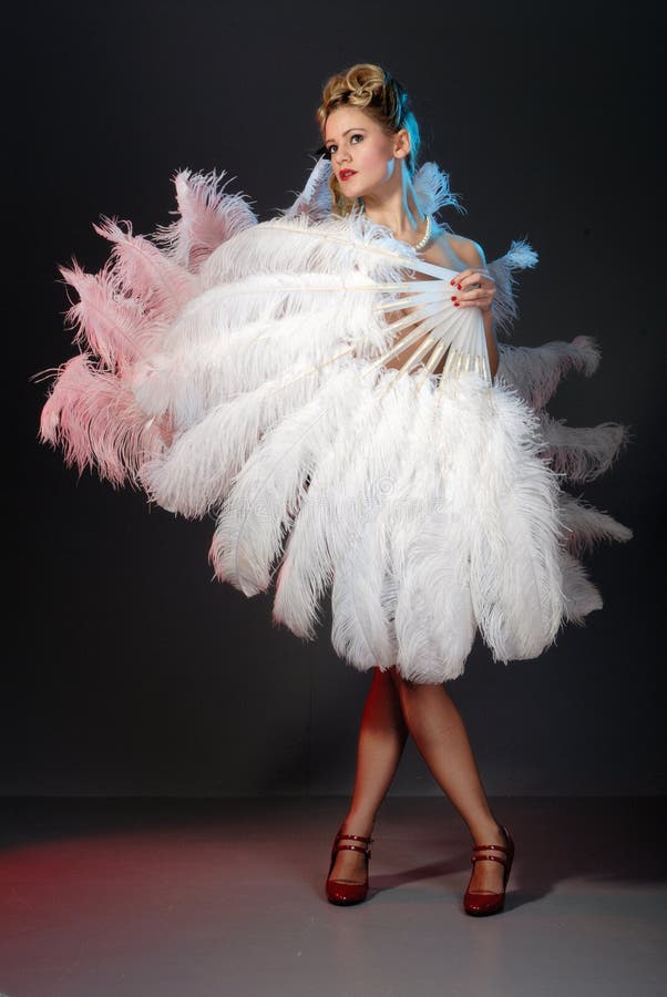 Burlesque fan dance artist with ostrich feather fan. Burlesque fan dance artist with ostrich feather fan