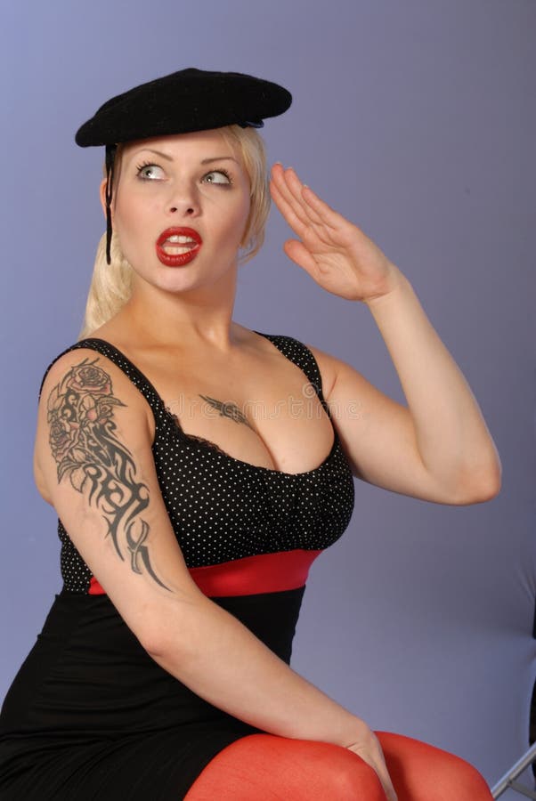 Burlesque cute girl with tattoo wearing black beret