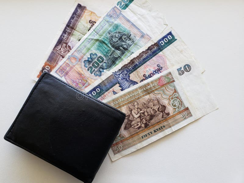 Burmese banknotes of different denominations and black leather wallet royalty free stock image Burmese banknotes of different denominations and black leather wallet royalty free stock image