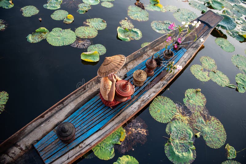 Burmese Intha woman in a rowing boat in the morning