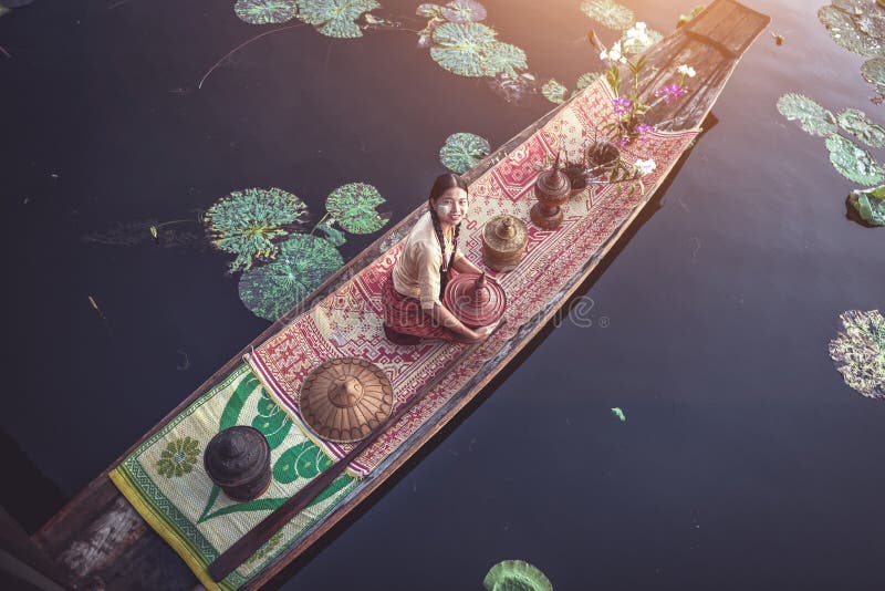 Burmese Intha woman in a rowing boat in the morning