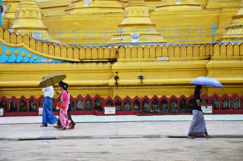 Burmese people walking at Shwemawdaw Paya Pagoda in Bago, Myanmar.