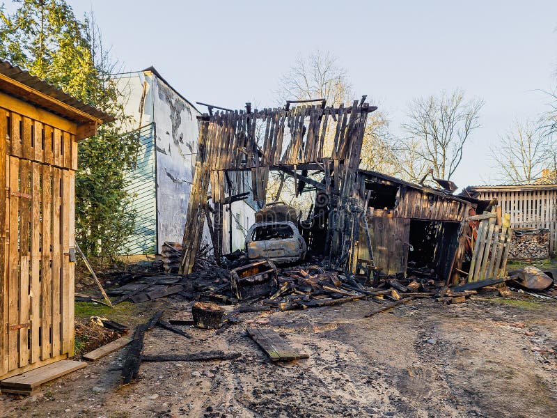 Burned barn, garage and car. Sunny spring day royalty free stock photography