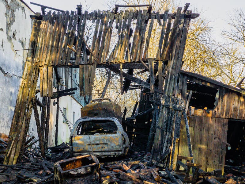 Burned barn, garage and car. Sunny spring day royalty free stock photo
