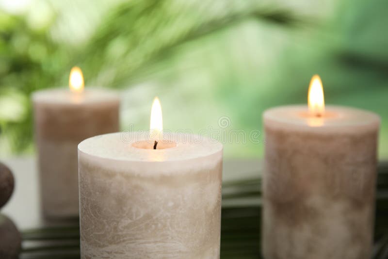 Burning Aromatic Candles On Green Background Stock Photo Image of