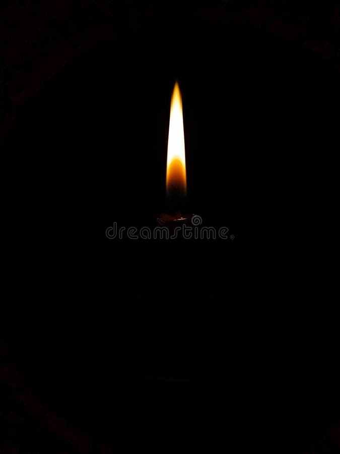 Burning Candle in a Candlestick on a Black Background Stock Photo ...