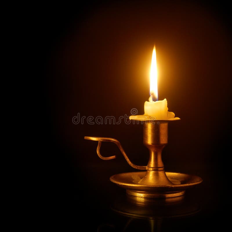 Burning candle on candlestick royalty free stock images