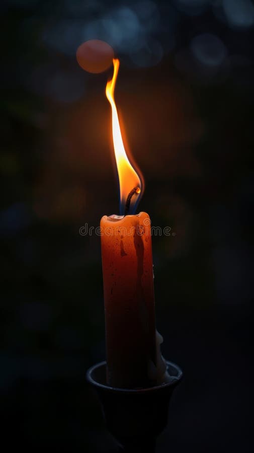 Burning candle in the dark royalty free stock photography