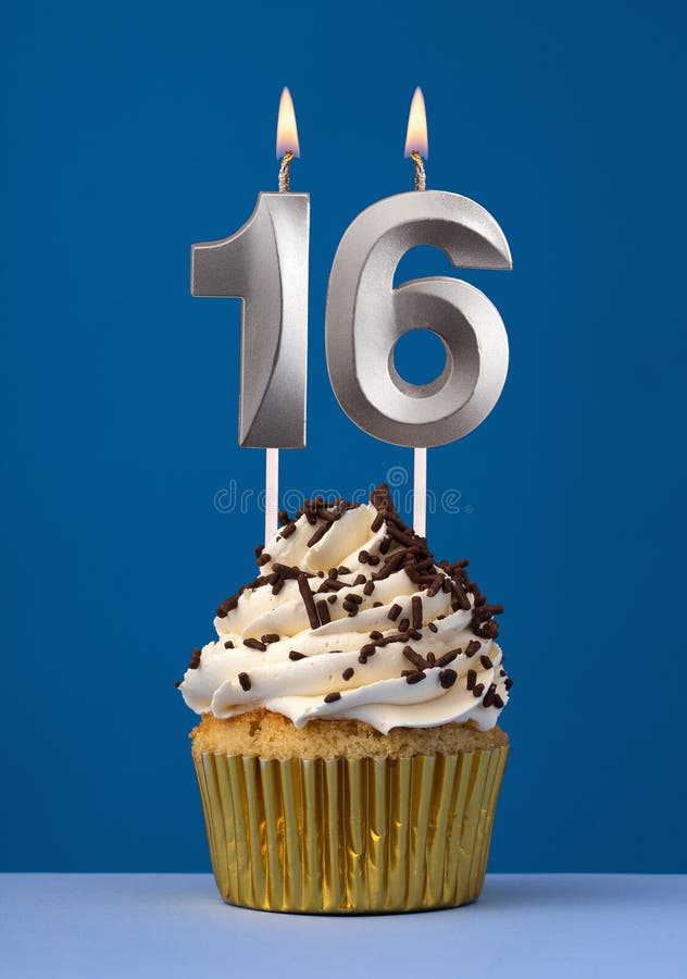Burning candle number 16 - Birthday card with cake on blue Background royalty free stock photo