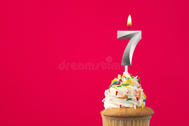 Burning candle number 7 - Birthday card with cake stock image