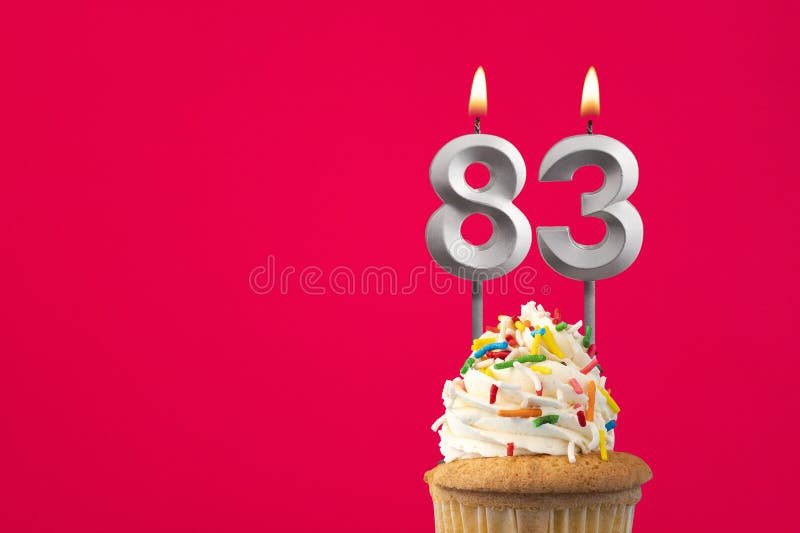 Burning candle number 83 - Birthday card with cake stock images