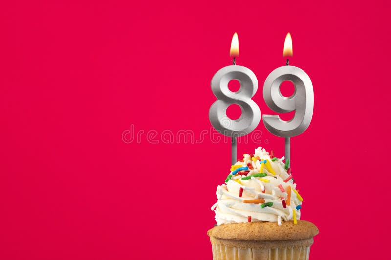 Burning candle number 89 - Birthday card with cake stock photography