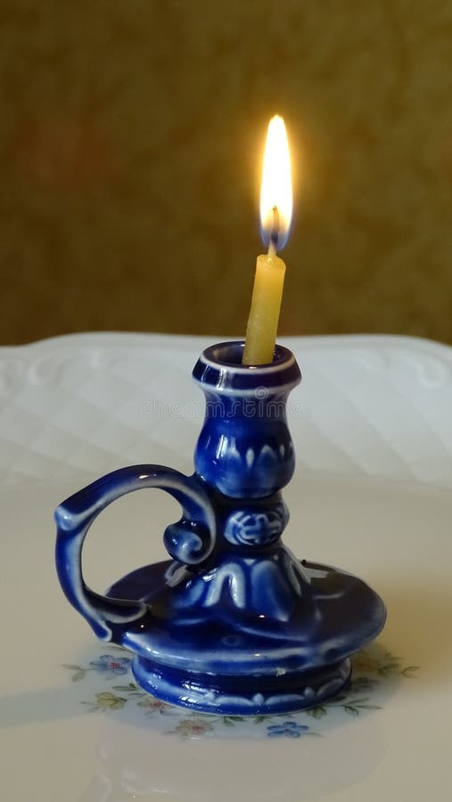 Burning Candle in a Porcelain Candlestick. Stock Photo Image of gold