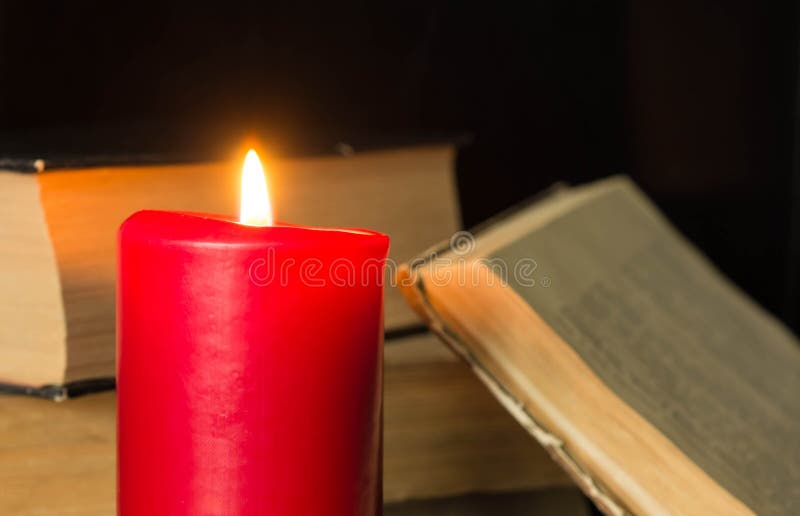 The Burning Candle Against the Old Book Stock Photo Image of
