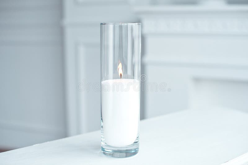 A burning candle tall glass vase. stock photo A burning candle tall glass vase. stock photo