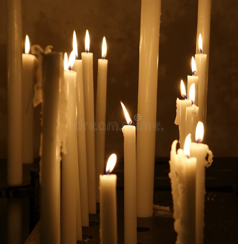 Three Candles Burning in a 13th Century English Parish Church Stock