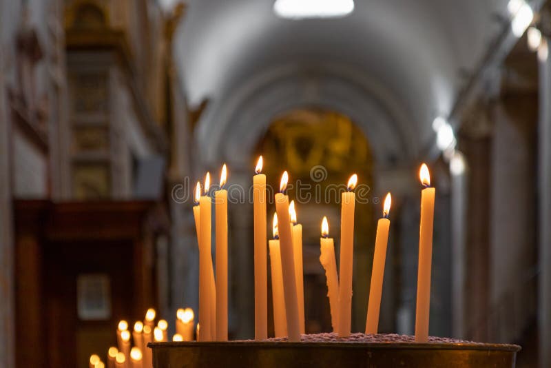 Burning Candles in the Catholic Church. Selective Focus. Bokeh. Stock
