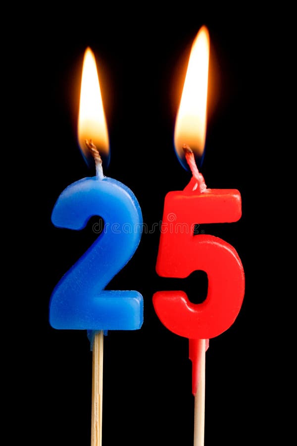 Burning candles in the form of 25 twenty five figures numbers, dates for cake isolated on black background. The concept of celeb