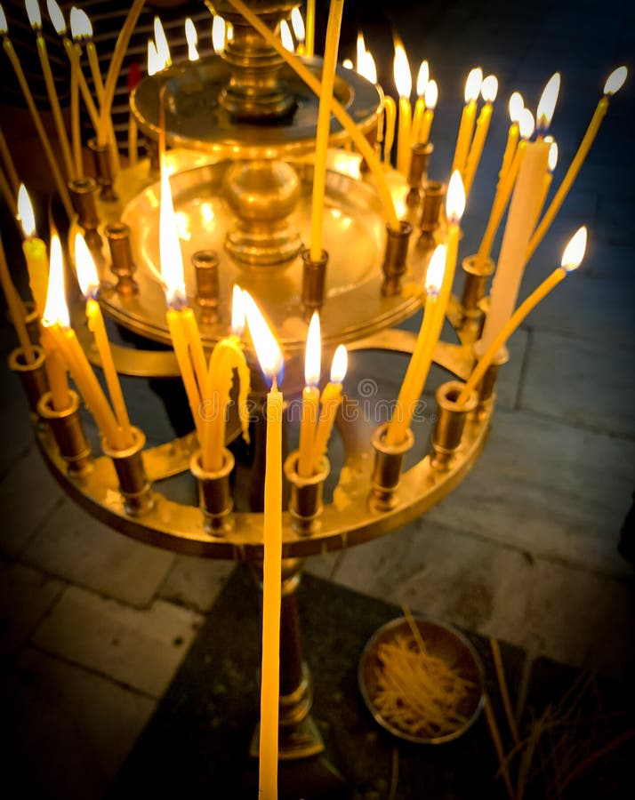 Burning Candles with One Lighted Candle in Orthodox Church. Editorial