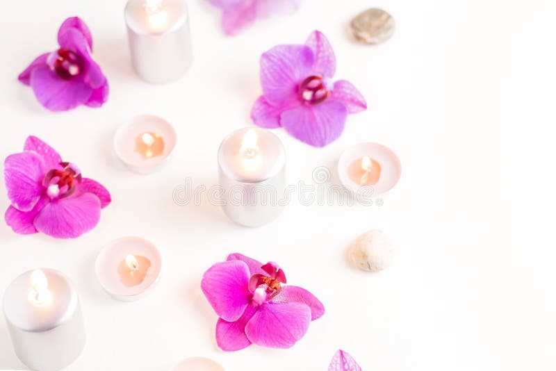 Burning candles and orchid flowers on wooden background. Relaxation spa concept royalty free stock photo Burning candles and orchid flowers on wooden background. Relaxation spa concept royalty free stock photo