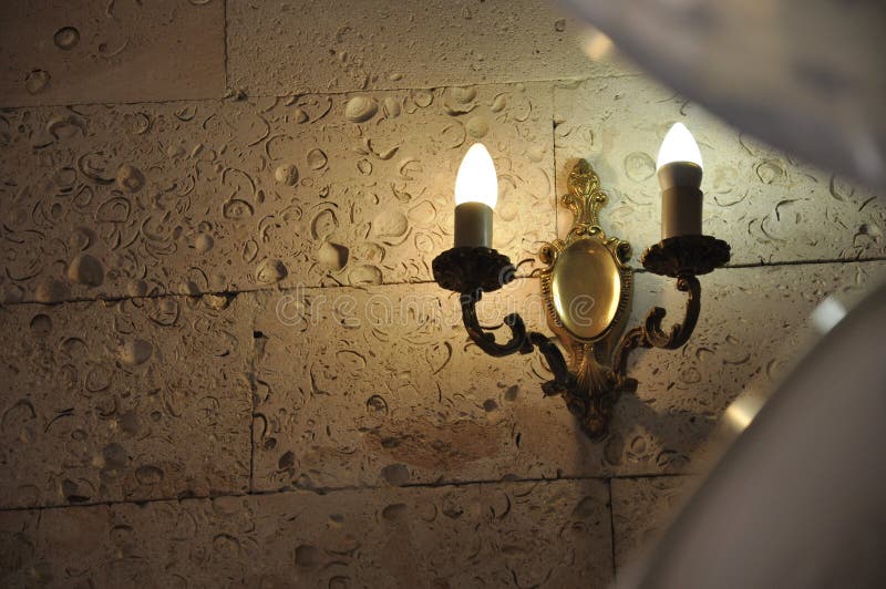 Burning Candles on the Stone Wall in Old Castle. Warm Light Stock Image