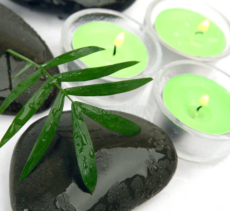 Burning candles and stones stock image. Image of leaf 26512963