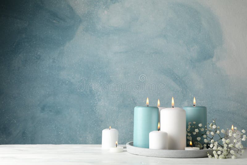 Burning candles, tray and flower against background, space for text royalty free stock photography