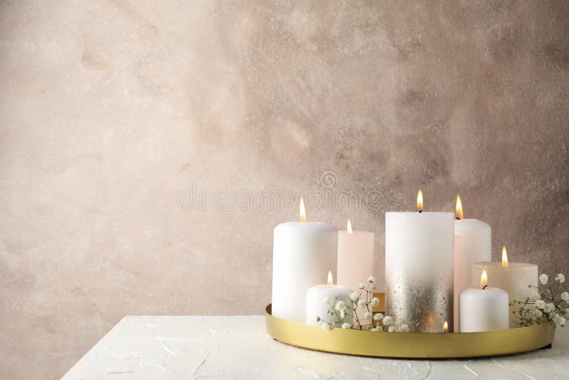 Burning candles, tray and flower on table, space for text royalty free stock photography