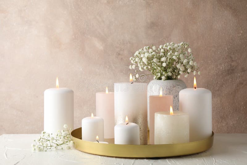 Burning candles, tray and flower on table, space for text royalty free stock image