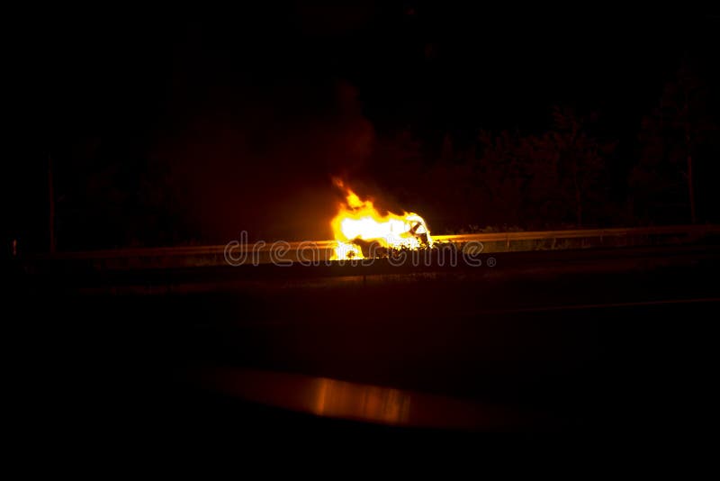 Burning Car after an Accident or Defect on the Highway Stock Image