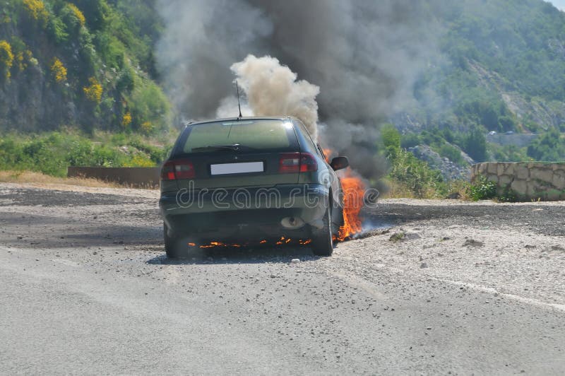Burning car on highway stock photo. Image of explosion 44603594