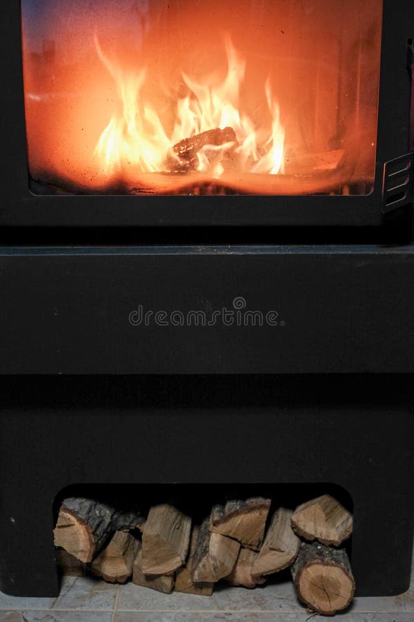 Burning Fire in the Fireplace and Firewood on the Floor. Arson, Fire