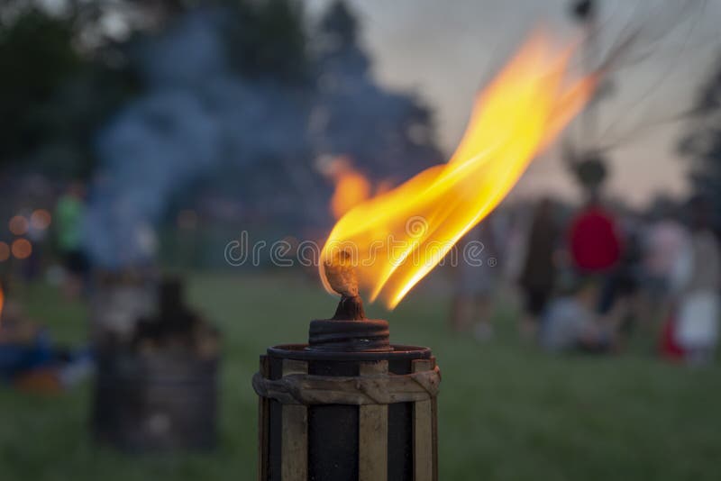 Burning flame of an outdoor torch at a party stock photo Burning flame of an outdoor torch at a party stock photo