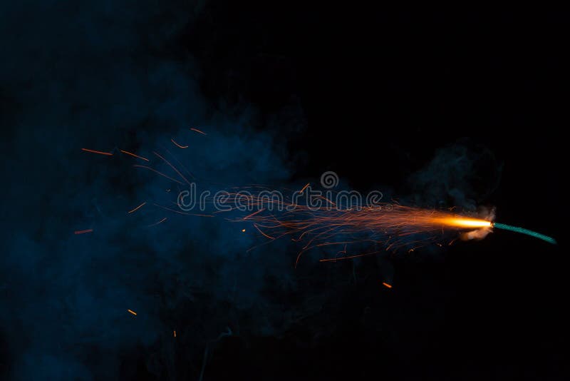 Burning fuse. Dynamite firecracker green fuse burn with sparkles and smoke  on black background. Stock Photo