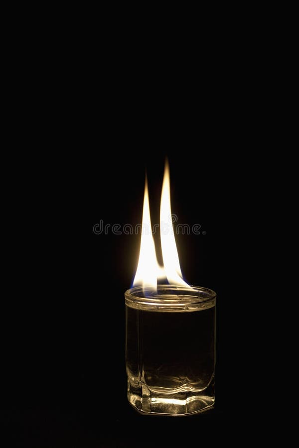 Burning glass with alcohol stock image. Image of addiction 29633727