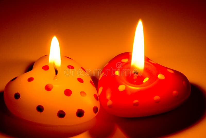 Burning heart shaped candles