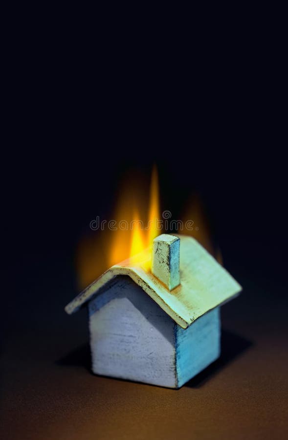 Multi colored toy house on fire. Good insurance, banking, real estate, security metaphor. Multi colored toy house on fire. Good insurance, banking, real estate, security metaphor