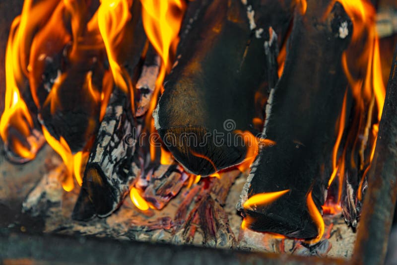 Burning Logs for Kindling a Fire, Flame and Smoke on Fire. Logs in a Barbecue for Frying Meat