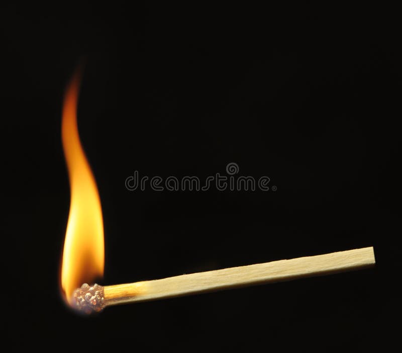 Burning match. A photo close up, a dark background