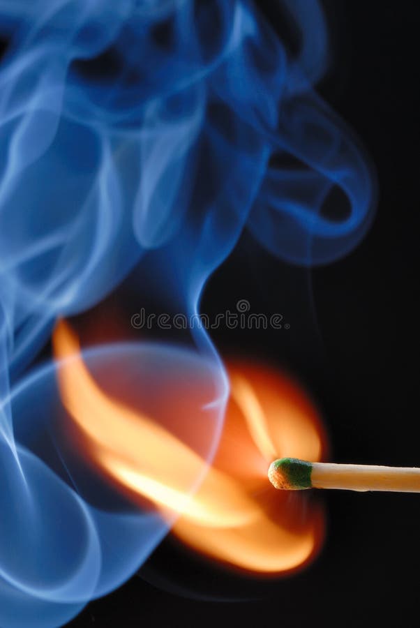 Macro of burning match and smoke on black background
