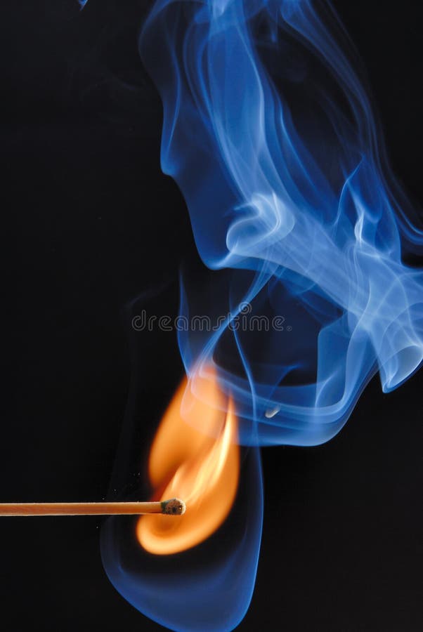 Macro of burning match and smoke on black background