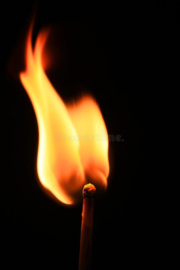 Macro of burning match on black background