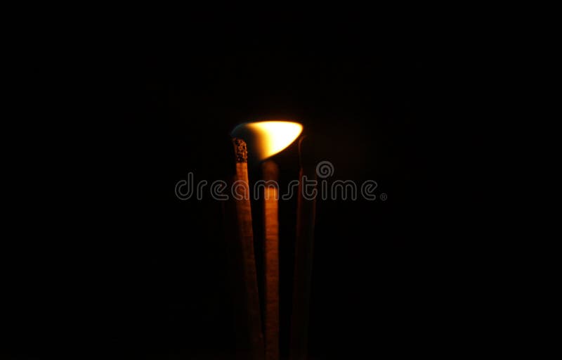 Burning matches in smoke on black background royalty free stock photography