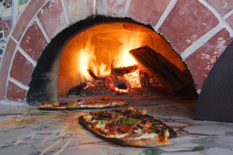 An image of Pizza fresh out of a wood burning oven. An image of Pizza fresh out of a wood burning oven