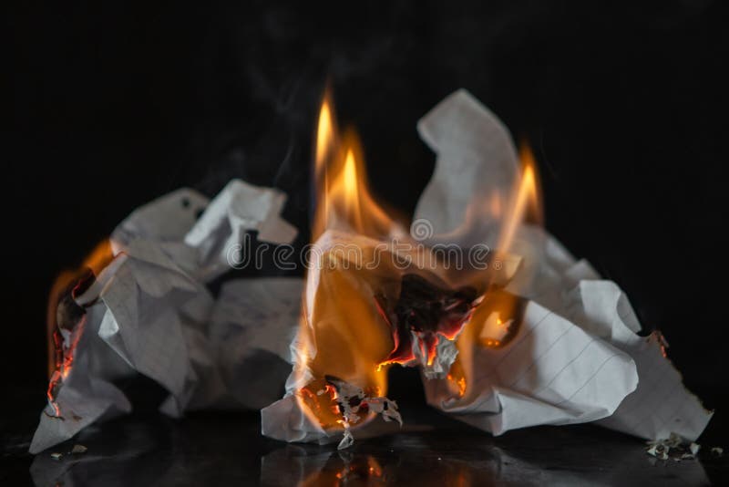 Burning paper on a black background. Fire and ashes from writing, memories
